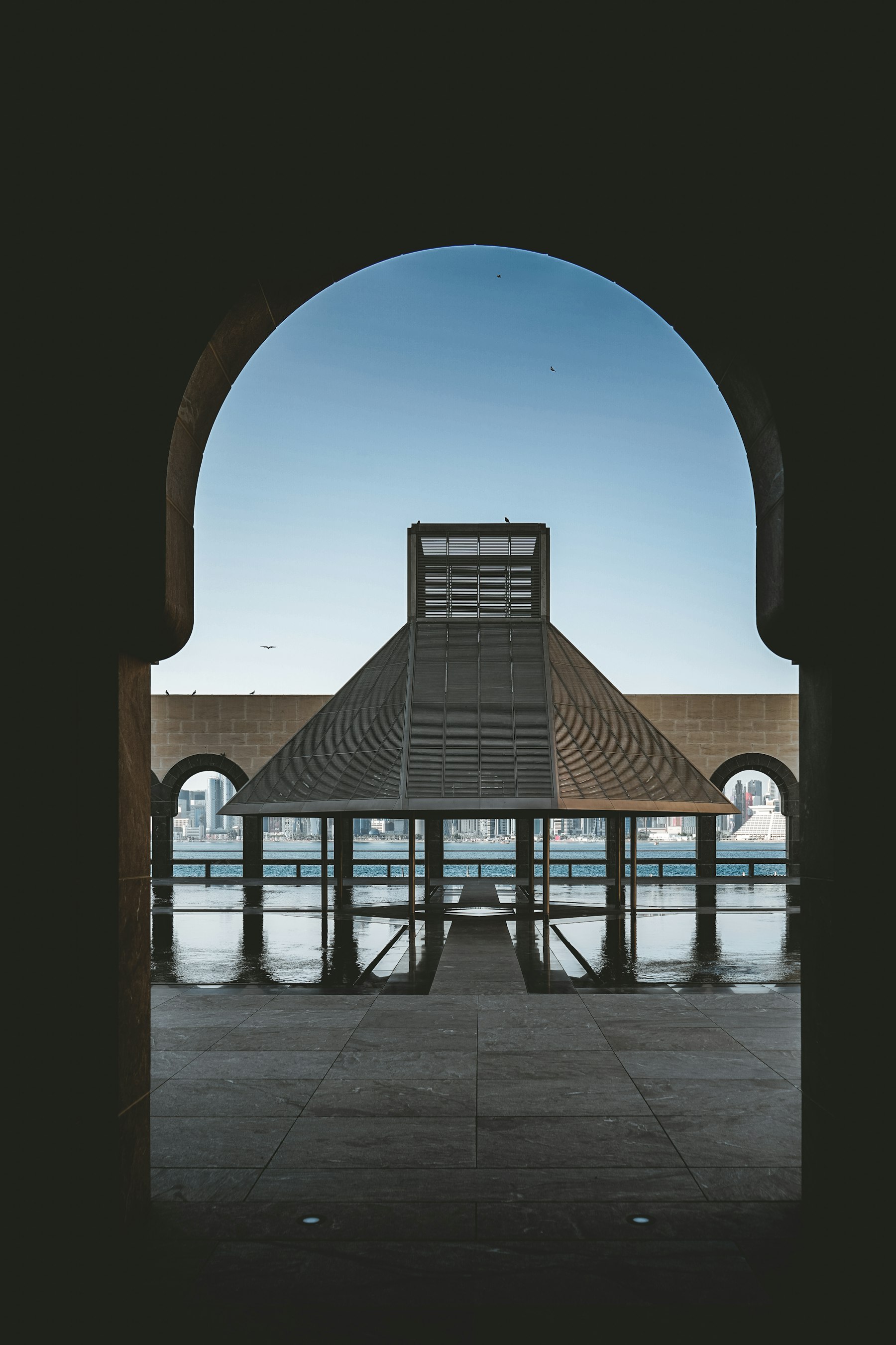 Stone archway and waterfront pavilion at the Museum of Islamic Art, Doha