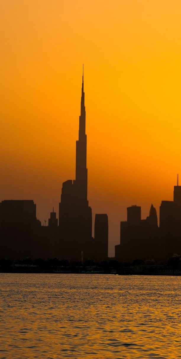 Burj Khalifa silhouetted in amber sunset light